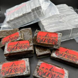 Premium Dry Sift 120U hash by Bad Berred Farm, golden trichomes with a fine, clean texture in branded glass packaging
