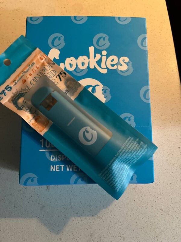 Cookies THC disposable vape pen with golden oil, sleek design, and clear branding for easy, on-the-go use.