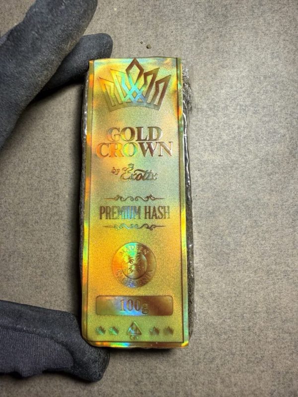 Gold Crown Hash showing golden trichomes and premium solventless craftsmanship during the hash-making process.trichomes and premium solventless craftsmanship during the hash-making process.
