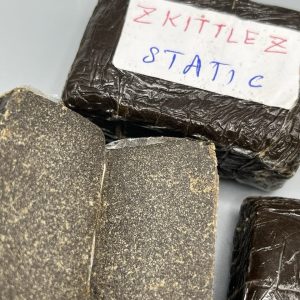 Buy Zkittlez Hash online showing premium resin-rich hash with sweet fruity terpene profile.